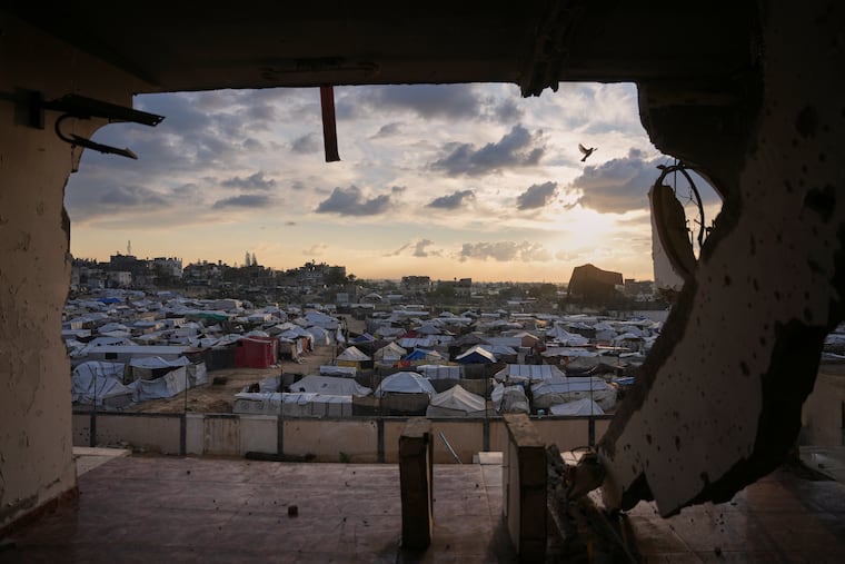 Seen from a building heavily damaged during the Israeli air and ground operations, tents fill a makeshift camp for displaced Palestinians in Deir al-Balah, central Gaza Strip, on Dec. 13.