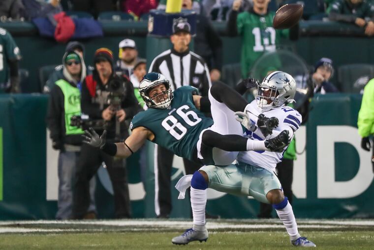 Eagles tight end Zach Ertz is brought down by Dallas Cowboys free safety Xavier Woods in the first half of a game at Lincoln Financial Field in South Philadelphia on Sunday, Dec. 22, 2019.