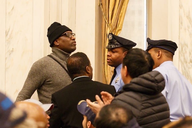 Black Lives Matter activist Asa Khalif, left, reacted to remarks during a Philadelphia City Council meeting last year.