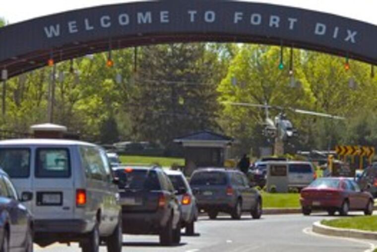 Cars are backed up entering the main gate to Fort Dix on County Route 68 in Wrightstown as security personnel check IDs.