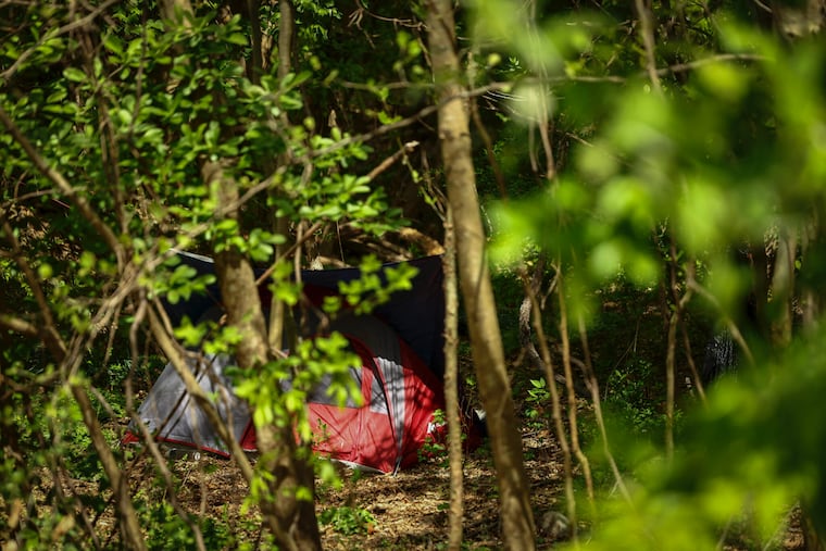 A homeless encampment sits in the woods off the canal path along the Delaware River. Advocates for the homeless are concerned about the impact of the recent heat wave on people who are unhoused.