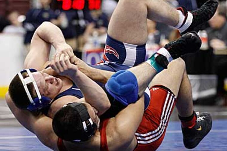 Souderton's Joe Stolfi, bottom, flips Pittston Area's Jason Laboranti
during their Class AAA 215-pound preliminary match. (Matt Slocum/AP)