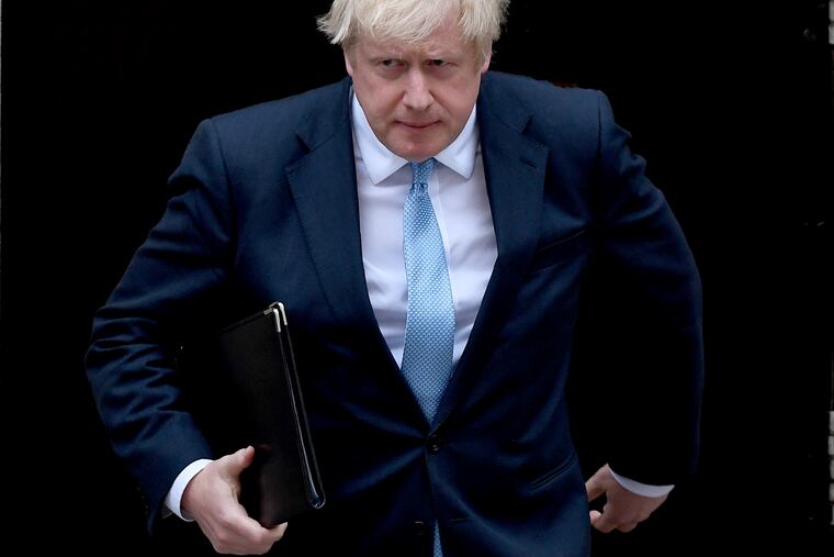 Britain's Prime Minister Boris Johnson walks towards a podium to speak to the media outside 10 Downing Street in London, Monday, Sept. 2, 2019. Johnson says he doesn't want an election amid the Brexit crisis and issued a rallying cry to lawmakers to back him in securing a Brexit deal.