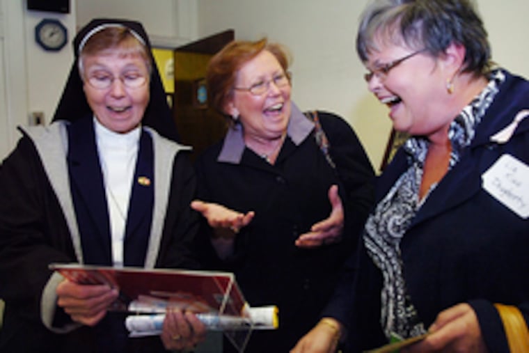 Laughing at photos are (from left) Sister Jane McFadden, class of '60; Ellen McConney, '63; and Liz King Dougherty, '60.
