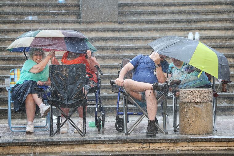 Philadelphia Orchestra fans braved the storm as two bands of rain deluged Penn's Landing Friday before a planned concert, which was then canceled.