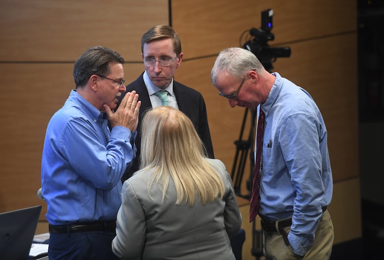 Scott Lambert, chair of the East Whiteland board of supervisors, left, confers with township officials about the data center proposal on April 14, 2026.