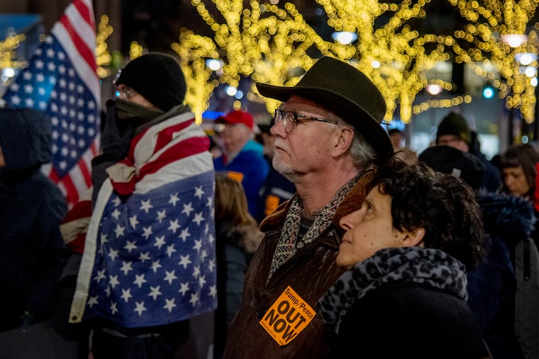 Pat and Sam Hughes of Narberth join other protesters gathered at City Hall's Dilworth Plaza Feb. 5, 2020, one of a number of nationwide "Reject the Cover Up: Demand Trump/Pence #OutNow" rallies protesting President Trump's impeachment acquittal.