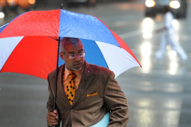Damon K. Roberts ran through the rain at 15th and Market Streets on Thursday. A drought watch, called for Philadelphia and much of the rest of the state after the summer’s dry start and before August’s drenching rains, remains in effect. (Clem Murray / Staff Photographer)