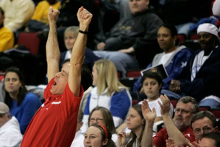 Rancocas Valley coach Jay Flanagan raises his arms in triumph as the final buzzer sounds after his team's championship win.