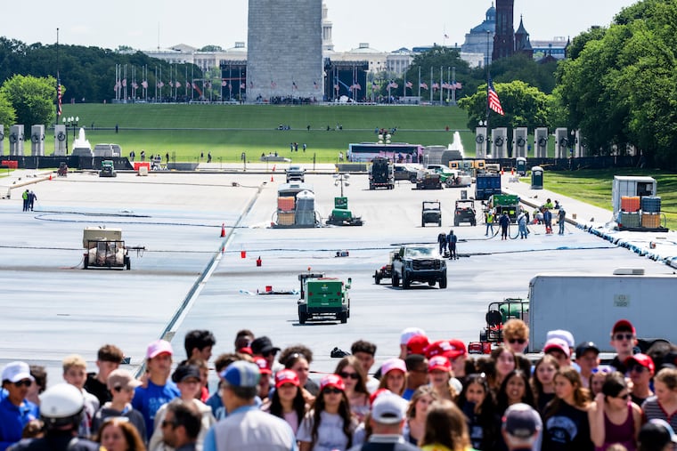 A school group poses for a picture as crews behind them paint the bottom of the Lincoln Memorial Reflecting Pool in Washington, May 15, 2026.