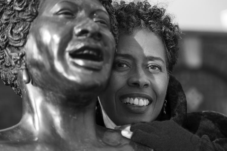 Vinnie Bagwell with the life-size bronze statue of singer Ella Fitzgerald titled "The First Lady of Jazz" at the Yonkers Metro-North Station.