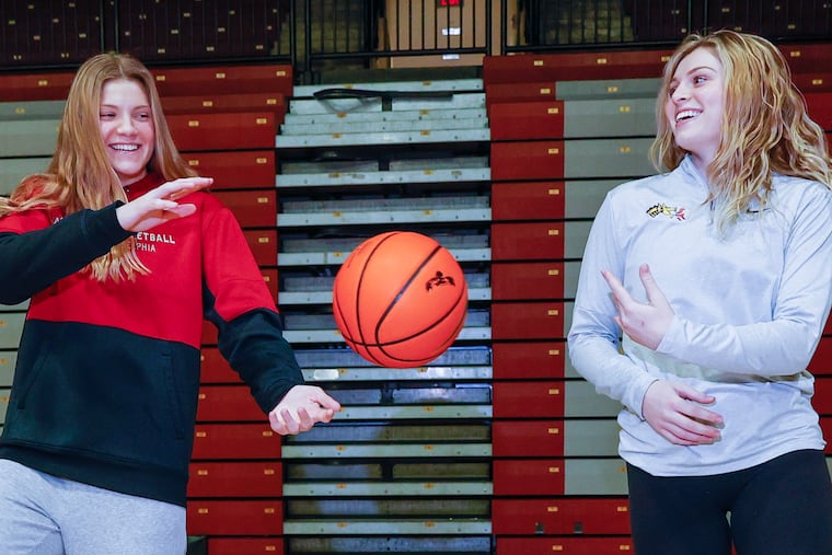 Drexel director of basketball operations Tessa Brugler (right) passes the basketball to her sister, St. Joseph's forward Talya Brugler. The Bruglers are one of three sets of sisters on the City 6 hoops scene.
