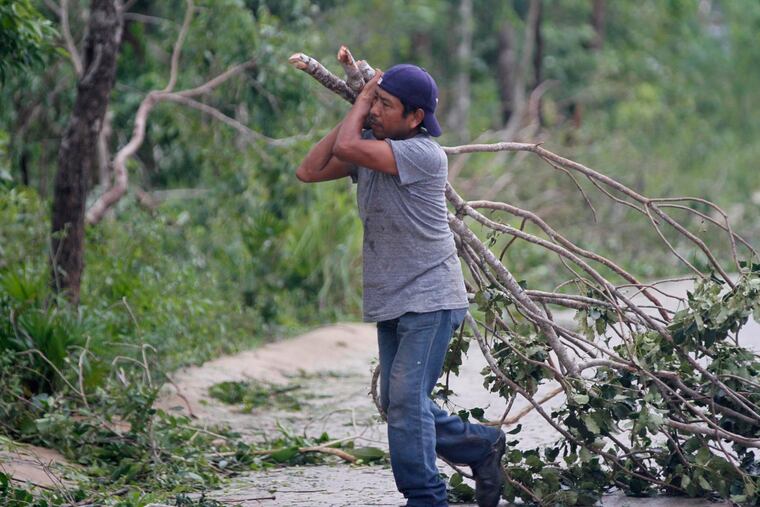 A worker hauled off fallen branches after Hurricane Zeta passed through Playa del Carmen, Mexico, early Tuesday. Zeta is leaving Mexico’s Yucatan Peninsula on a path that could hit near New Orleans on Wednesday.