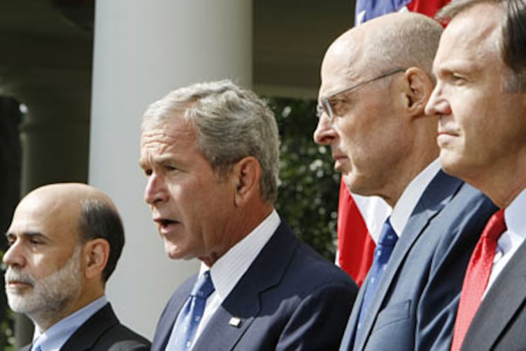 President Bush accompanied by, from left, Fed Chairman Ben Bernanke, Treasury Sec. Henry Paulson, and SEC Chairman Christopher Cox, delivered a statement about the economy and government efforts to remedy the crisis on Friday. (AP Photo/Pablo Martinez Monsivais)