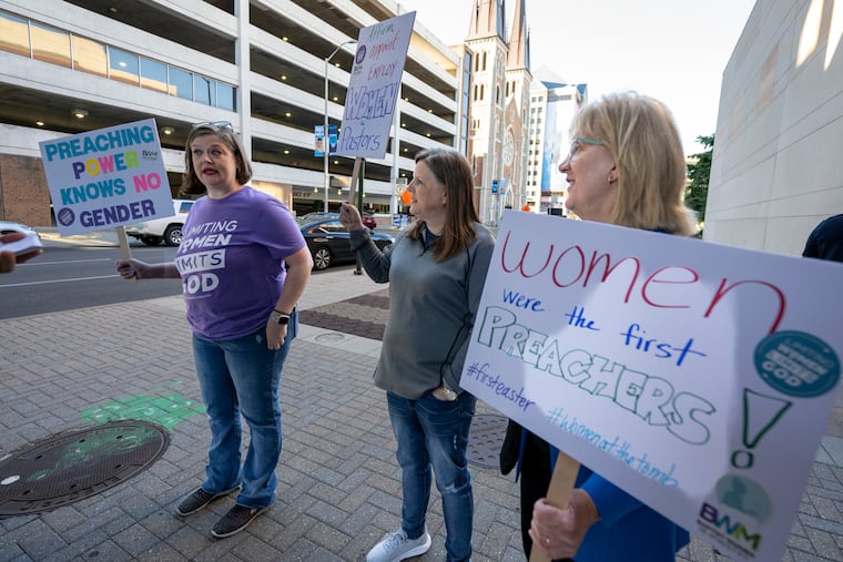 Nikki Hardeman, Atlanta, Georgia, director of legislating for Baptist Women in Ministry, from left; Meredith Stone, executive director of Baptist Women in Ministry, and Christa Brown, an advocate for the Baptist Women in Ministry, stand outside the venue of a Southern Baptist Convention annual meeting in Indianapolis.