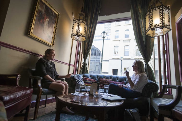 Kelly Christian (left) and Jackie Gilbert enjoy a drink by the front window at 1 Tippling Place.