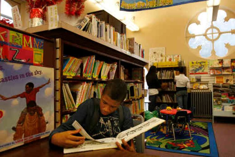 Dequon Townend, 13, above, reads a book at the Darby Free Library. The library is housed in a building at 10th and Main Streets, left, that was built in 1872. A cut in state funding has left the library $30,000 short this year.