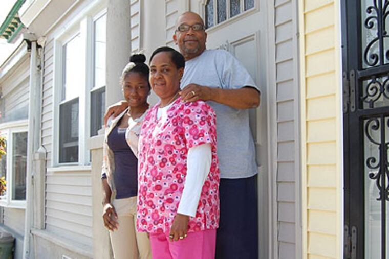 Valerie and Thaddeus Garfield and Kimberly Johnson at their new house on South 46th Street. ALAN J. HEAVENS