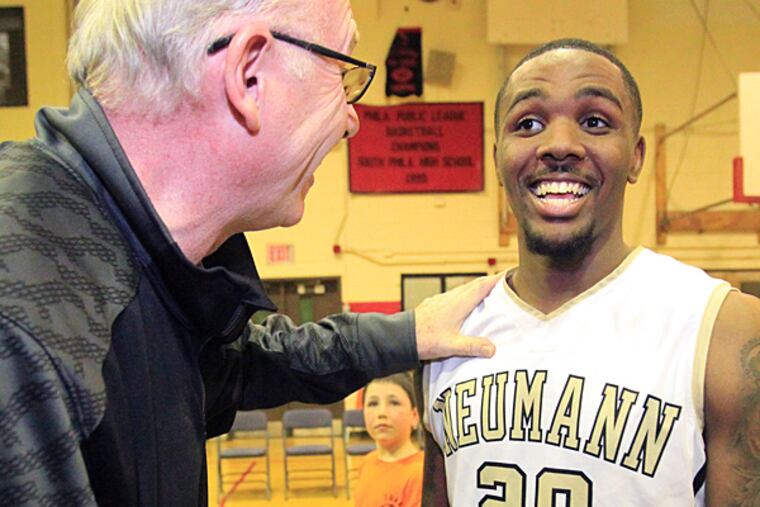 Ja'Quan Newton, right, of Neumann-Goretti is congratulated by
University of Miami Coach Jim larranaga, left, after Newton broke the
all-time Catholic League scoring record on March 18, 2014. (Charles Fox/Staff Photographer)