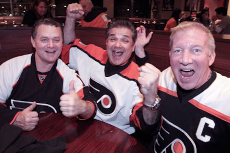Flyers fans (from left) Ray Fitz, Dr. Rob DiMaio and team captain Joseph Daly sure seem content watching the playoffs at Xfinity Live!
