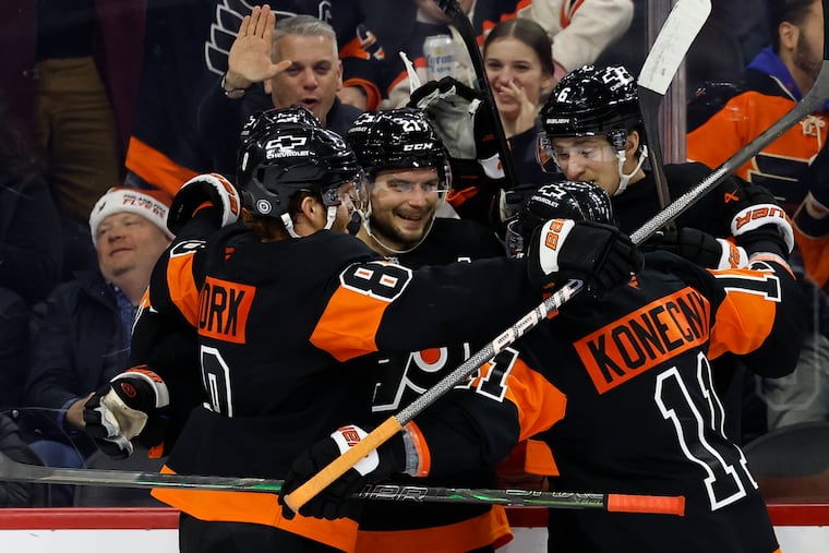 Former Flyers center Scott Laughton celebrates his empty net goal with his teammates against the Detroit Red Wings.