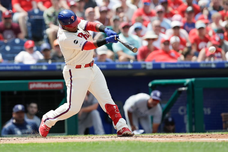 The Phillies' Jean Segura hits a first-inning RBI single against the Padres.