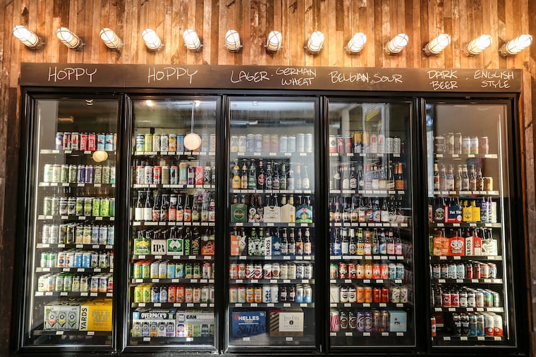 Hundred bottles of beer on the wall, a hundred bottles of beer: The fridge at Local 44, 4333 Spruce St.
