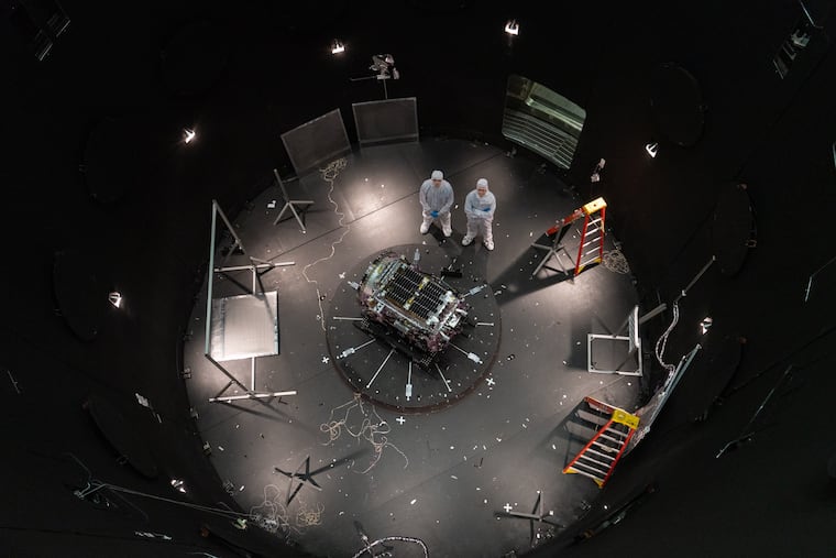 This photo provided by NASA shows Kieran Wilson, LINK’s principal investigator, and Hunter Robertson, a space systems engineer, both at Katalyst Space, standing next to their spacecraft inside the Space Environment Simulator at NASA’s Goddard Space Flight Center in Greenbelt, Md., April 17, 2026, ahead of thermal vacuum testing.