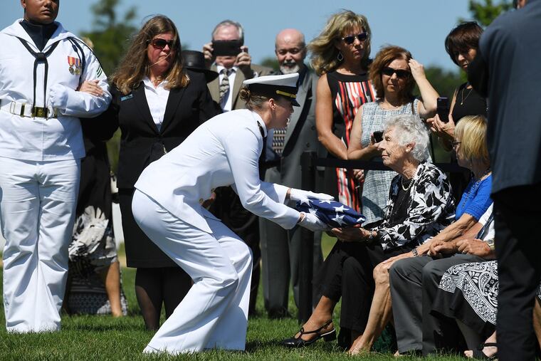 Lt. Danielle Garbarino presents a flag to Lucy Liebenow during the funeral of her husband, William.