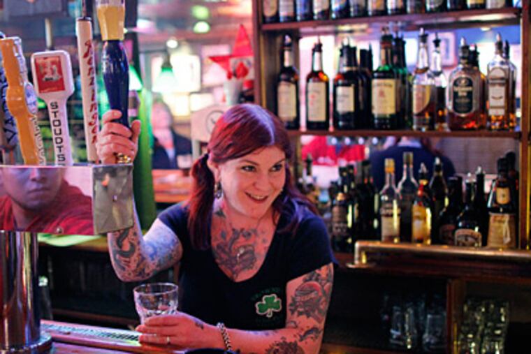 Bartender Kristie Matt, pulling a draft beer at Brownie’s in Old City, says moving the closing time to 3 a.m. could result in "an extra hour for chaos."
