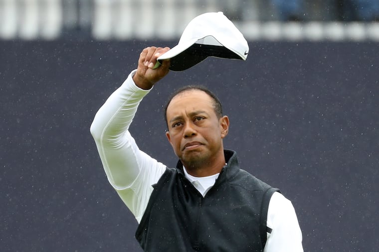 Tiger Woods of the United States waves his hat to the crowd as he completes his second round of the British Open Golf Championships at Royal Portrush in Northern Ireland. Woods finished at 6 over par for the two rounds and missed the cut.