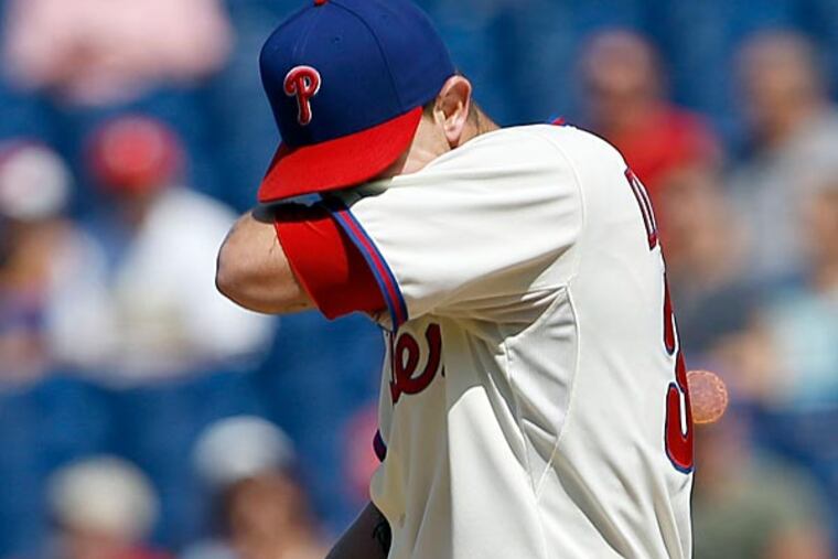 Phillies' pitcher Justin De Fratus wipes his face after giving up a run. (Yong Kim/Staff Photographer)