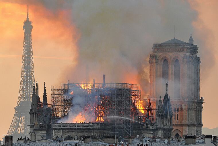 In this image made available on Tuesday April 16, 2019 flames and smoke rise from the blaze after the spire toppled over on Notre Dame cathedral in Paris, Monday, April 15, 2019. An inferno that raged through Notre Dame Cathedral for more than 12 hours destroyed its spire and its roof but spared its twin medieval bell towers, and a frantic rescue effort saved the monument's "most precious treasures," including the Crown of Thorns purportedly worn by Jesus, officials said Tuesday. (AP Photo/Thierry Mallet)