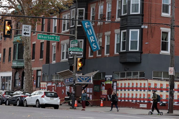 Removal of the Meglio Furs sign at Broad and Wharton Streets in Philadelphia last week.