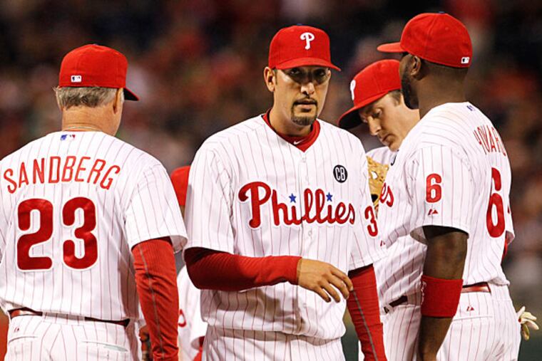 Mike Adams is taken out by manager Ryne Sandberg. (Ron Cortes/Staff Photographer)