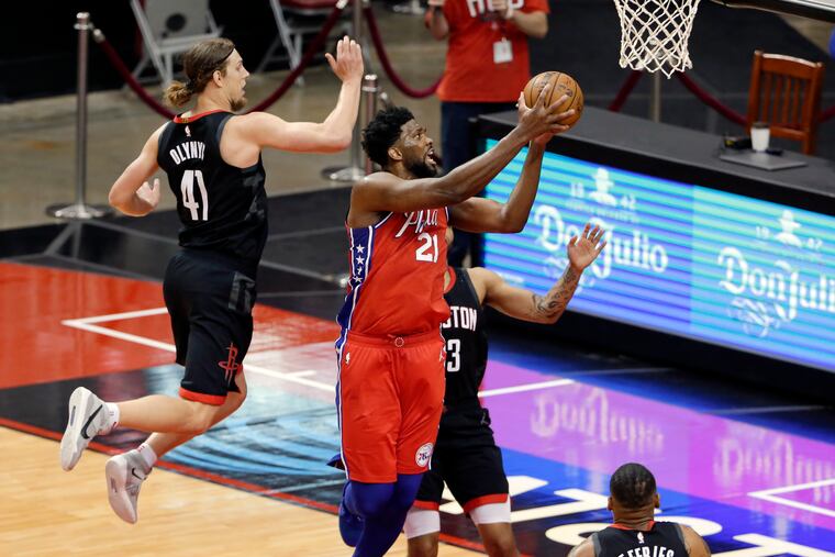 Joel Embiid gets a shot up past Houston Rockets forward Kelly Olynyk (41) and guard Kevin Porter Jr. during the second half.