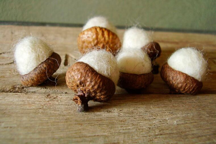 This product image provided by House of Moss shows acorns made with wool in Dundee, Ore. Alison Comfort is inspired by the forest floor to create realistic natural forms like mushrooms, pebbles, moss and acorns. Using eco-friendly wool helps her tie the organic elements of the craft together. (AP Photo/House of Moss, Alison Comfort)