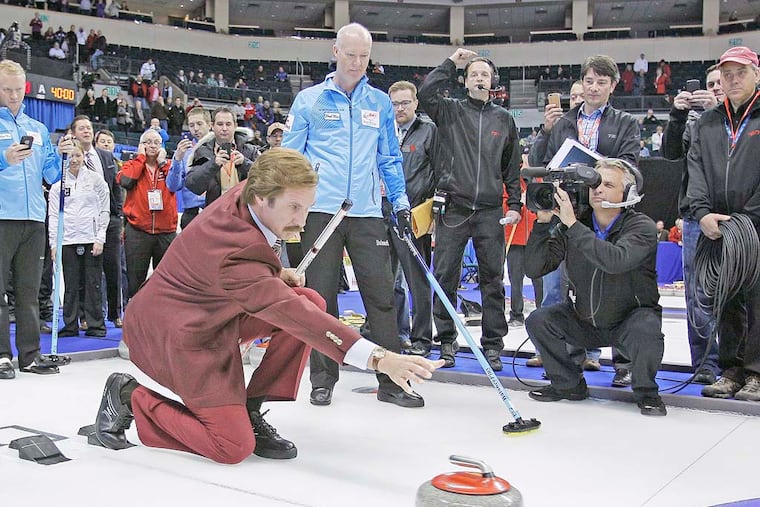 Will Ferrell as "Ron Burgundy" releases a rock as Glenn Howard and his team look on after the opening ceremonies at the 2013 Roar Of The Rings championship in Winnipeg.