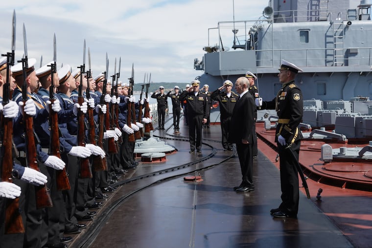 Russian President Vladimir Putin visits the Varyag missile cruiser on Wednesday to watch a military exercise near Yuzhno-Sakhalinsk on Sakhalin Island, Russia.