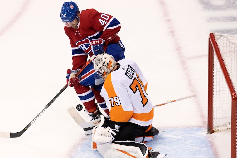Philadelphia Flyers goaltender Carter Hart (79) makes a save under pressure from Montreal Canadiens right wing Joel Armia (40).