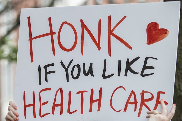 A protester’s sign outside the Philadelphia office of Sen. Pat Toomey (R., Pa.) last month. The health-care bill that Toomey helped craft would hit Pennsylvania hard. In some ways, it could be even worse in New Jersey. MICHAEL BRYANT / Staff Photographer