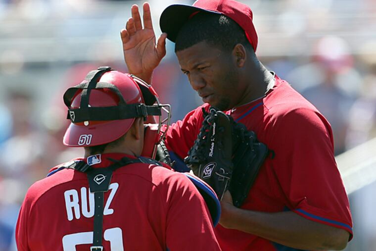 Phillies pitcher Roberto Hernandez talks to catcher Carlos Ruiz in the fourth inning against the Blue Jays on Wednesday. (Yong Kim/Staff Photographer)