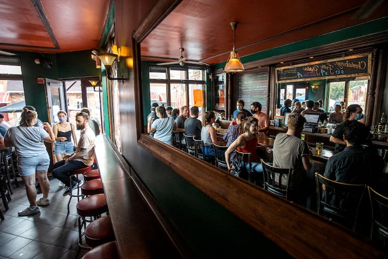 The crowd is reflected in a mirror at the Fountain Porter at 1601 S 10th St, Philadelphia on Aug. 26, 2021.
