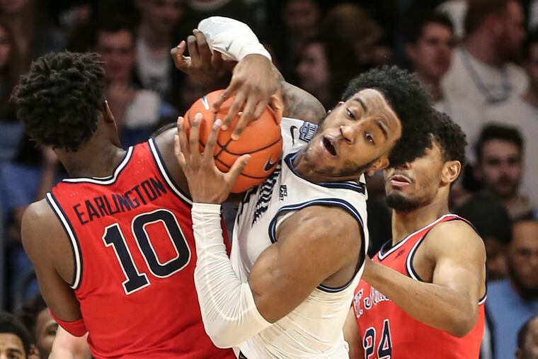 Villanova's Saddiq Bey breaks free of St. John's Marcellus Earlington (left) and Nick Rutherford (right) during the 2nd half at Finneran Pavilion on Feb. 26.