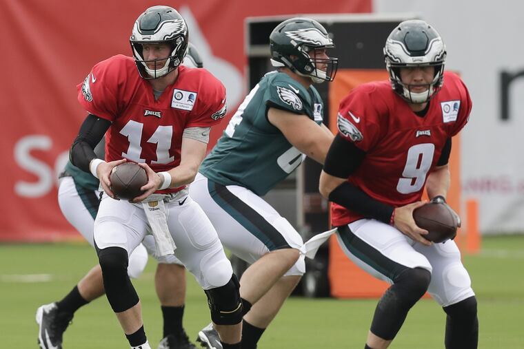 Eagles quarterback Carson Wentz holds out the football during training camp drills at the NovaCare Complex in South Philadelphia on Saturday, July 28, 2018. YONG KIM / Staff Photographer