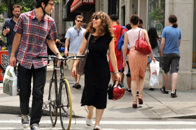 Walnut Street in Center City. Graham Shapiro and Lior Levy ride their bikes in from West Philadelphia. They say parking is one of the negatives. (Tom Gralish / Staff Photographer)