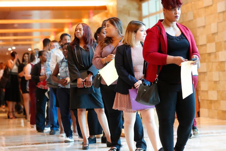 In this Tuesday, June 4, 2019 photo, job applicants line up at the Seminole Hard Rock Hotel & Casino Hollywood during a job fair in Hollywood, Fla. On Friday, July 5, the U.S. government issues the June jobs report.