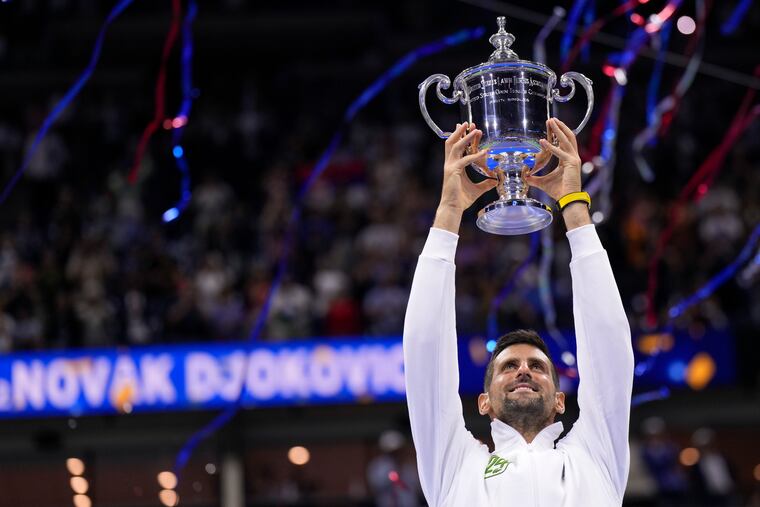Novak Djokovic holds up the championship trophy after winning the U.S. Open on Sunday.