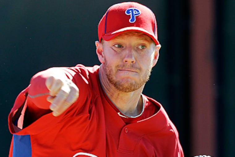 Philadelphia Phillies' Roy Halladay throws during spring training baseball practice in Clearwater, Fla. (AP Photo/Eric Gay)