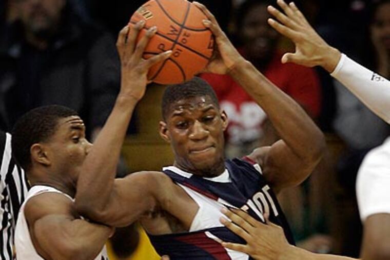 Penn Wood's Aaron Brown keeps the ball away from Plymouth Whitemarsh'sSam Pygatt in the first quarter of high school basketball action at Villanova University earlier this year. (Laurence Kesterson / Staff Photographer)